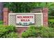 Belmonte Hills community sign with brick columns and a lattice backdrop, framed by lush green landscaping at 114 Belmonte Sw Dr, Atlanta, GA 30311