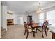 An open dining room with a chandelier seamlessly connects to the cozy living room at 114 Belmonte Sw Dr, Atlanta, GA 30311