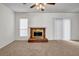 Spacious living room featuring plush carpeting and a classic brick fireplace with a gold trim at 114 Belmonte Sw Dr, Atlanta, GA 30311