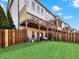 View of a well-maintained backyard with a wooden fence and a deck overlooking the lawn at 2124 Silas Nw Way, Atlanta, GA 30318