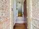 Inviting entryway with hardwood floors, brick accent wall, and staircase at 2124 Silas Nw Way, Atlanta, GA 30318