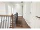 Second floor hallway with hardwood floors, natural light from windows, and white doors at 2124 Silas Nw Way, Atlanta, GA 30318