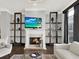 Bright living room featuring a fireplace, built-in shelving, modern decor, and a large TV at 2124 Silas Nw Way, Atlanta, GA 30318