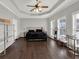 Large main bedroom with tray ceilings, hardwood floors, a bed, and natural light from the windows at 2124 Silas Nw Way, Atlanta, GA 30318