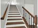 Staircase featuring hardwood steps, white risers, and dark railings at 2124 Silas Nw Way, Atlanta, GA 30318