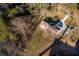 A birds-eye-view of the new home and its large lot, framed by bare trees, defined by a yellow property line at 770 Winding Creek Trl, Dacula, GA 30019