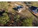 Aerial view shows a home on a large lot with many trees, and a defined yard area marked in yellow paint at 770 Winding Creek Trl, Dacula, GA 30019