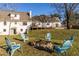 Backyard view with seating area, a fire pit, lush green grass, and a view of the exterior of the house at 770 Winding Creek Trl, Dacula, GA 30019