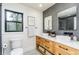 Bathroom with a double sink vanity, modern fixtures, wood cabinetry, and tiled flooring and a tiled shower at 770 Winding Creek Trl, Dacula, GA 30019