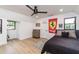 Teen's bedroom showcasing fun wall art, a bed, a desk area, a ceiling fan, and wood-look flooring at 770 Winding Creek Trl, Dacula, GA 30019