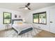 Sunlit bedroom with hardwood floors, neutral walls, and black framed windows overlooking a private backyard at 770 Winding Creek Trl, Dacula, GA 30019