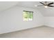 Bedroom with light-colored carpeting, a window overlooking greenery, white walls, and a contemporary ceiling fan at 770 Winding Creek Trl, Dacula, GA 30019