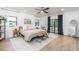 Bright bedroom with modern decor, ceiling fan, and access to a deck at 770 Winding Creek Trl, Dacula, GA 30019