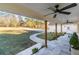 Inviting covered porch with tiled flooring, ceiling fans, and a view of the long driveway and lush front lawn at 770 Winding Creek Trl, Dacula, GA 30019