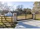 Gated driveway entrance to a beautiful home with a manicured lawn at 770 Winding Creek Trl, Dacula, GA 30019