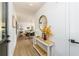 Bright entryway featuring hardwood floors, a console table, and an open view of the dining area at 770 Winding Creek Trl, Dacula, GA 30019