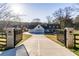 Grand entrance with a gated driveway, manicured lawn, and a charming exterior elevation at 770 Winding Creek Trl, Dacula, GA 30019