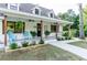 Inviting front porch with rocking chairs, plants, and stylish decor at 770 Winding Creek Trl, Dacula, GA 30019