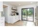 Kitchen with white cabinets, stainless steel refrigerator, breakfast bar, and sliding glass door to the deck at 770 Winding Creek Trl, Dacula, GA 30019