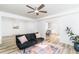 A modern living room that flows into the dining and kitchen; wood floors; neutral paint at 770 Winding Creek Trl, Dacula, GA 30019