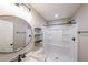 Modern bathroom featuring a shower, floating shelves, round mirror, and neutral color palette at 1261 Lavista Ne Rd # B3, Atlanta, GA 30324