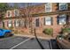 Classic brick townhome featuring symmetrical design, black shutters, and well-kept landscaping at 1261 Lavista Ne Rd # B3, Atlanta, GA 30324