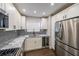 Bright kitchen features white cabinets, a wine cooler, stainless steel appliances, and marble countertops at 1261 Lavista Ne Rd # B3, Atlanta, GA 30324