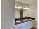 Bright bathroom featuring double vanity, granite countertop, and modern light fixture at 50 Senator Lake Dr, Douglasville, GA 30134