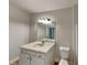 Classic bathroom with white vanity, sink, and matching toilet at 50 Senator Lake Dr, Douglasville, GA 30134