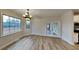 Bright dining room with modern chandelier and view to deck through French doors at 50 Senator Lake Dr, Douglasville, GA 30134