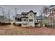 Rear exterior view of the home featuring a screened porch, deck, neutral siding, and mature trees in the backyard at 50 Senator Lake Dr, Douglasville, GA 30134