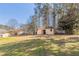 Spacious backyard view of the home and storage shed, perfect for outdoor activities at 774 Marthas Dr, Lawrenceville, GA 30045