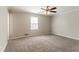 Carpeted bedroom with neutral walls, ample natural light, and a ceiling fan at 774 Marthas Dr, Lawrenceville, GA 30045