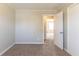 Bedroom featuring neutral-colored walls, carpet, and doors leading to other rooms at 774 Marthas Dr, Lawrenceville, GA 30045