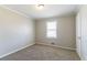 Cozy bedroom with a window letting in natural light and a neutral color scheme at 774 Marthas Dr, Lawrenceville, GA 30045