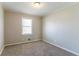 Bedroom featuring a window with natural light and neutral-colored walls and carpet at 774 Marthas Dr, Lawrenceville, GA 30045