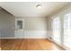 Well-lit dining area with hardwood floors and white-paneled walls, leading to a bright outdoor space at 774 Marthas Dr, Lawrenceville, GA 30045