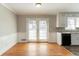 Cozy dining area features hardwood floors, white wainscoting, and sliding glass doors to the patio at 774 Marthas Dr, Lawrenceville, GA 30045