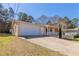 Traditional home with an attached garage and an extended driveway on a sunny day at 774 Marthas Dr, Lawrenceville, GA 30045