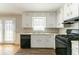 Well-organized kitchen with white cabinets and black appliances, offering a practical cooking space at 774 Marthas Dr, Lawrenceville, GA 30045