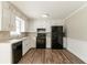 Functional kitchen with black appliances, neutral countertops, and white cabinets at 774 Marthas Dr, Lawrenceville, GA 30045