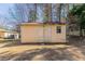 Storage shed in backyard of home, featuring double doors, one window and ample storage space at 774 Marthas Dr, Lawrenceville, GA 30045