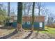 A brick and blue two-story home with a lush green backyard at 2664 Homeland Dr, Atlanta, GA 30360