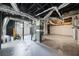 Unfinished basement with exposed pipes and concrete flooring at 2664 Homeland Dr, Atlanta, GA 30360