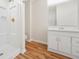 Bright bathroom featuring a shower, white vanity, and wood-look flooring at 2664 Homeland Dr, Atlanta, GA 30360