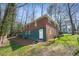 Two-story brick and teal home exterior showcasing a fenced backyard and mature trees at 2664 Homeland Dr, Atlanta, GA 30360