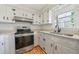 Cozy kitchen with white cabinets, modern appliances, and a bright window at 2664 Homeland Dr, Atlanta, GA 30360