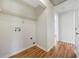 Well-lit laundry room with wood-look flooring and utility connections at 2664 Homeland Dr, Atlanta, GA 30360