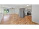 Bright living room open to kitchen with hardwood floors, ceiling fan and large window at 2664 Homeland Dr, Atlanta, GA 30360