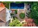 Stunning aerial view of a home featuring a private pool, brick patio and lush landscaping at 401 Peachtree Battle Nw Ave, Atlanta, GA 30305